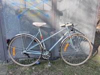 a bike leaning against a fence